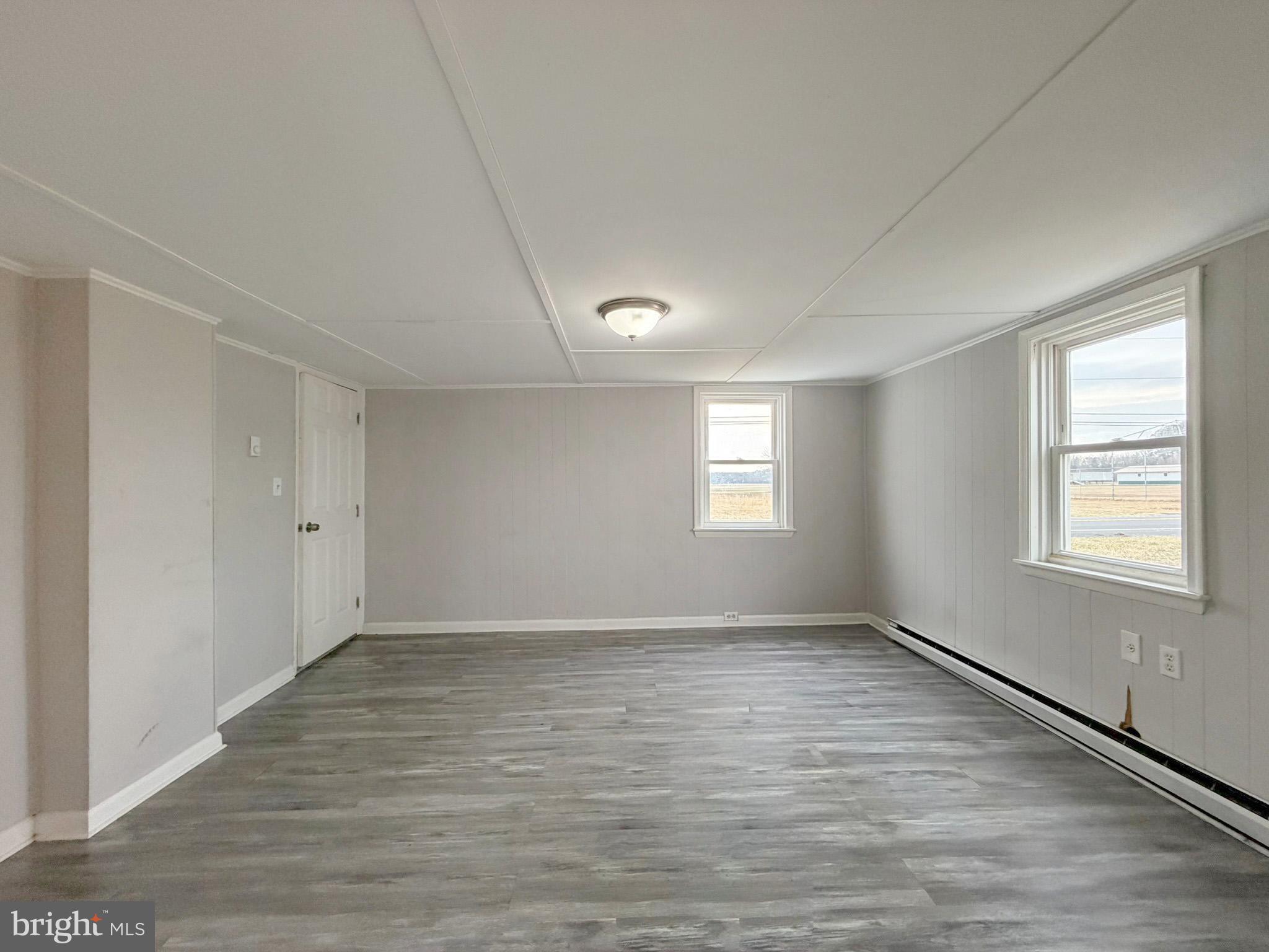 35534 Mt Hermon Road Pittsville, MD 21850 - Photo 24 of 52 a view of an empty room with wooden floor and a window