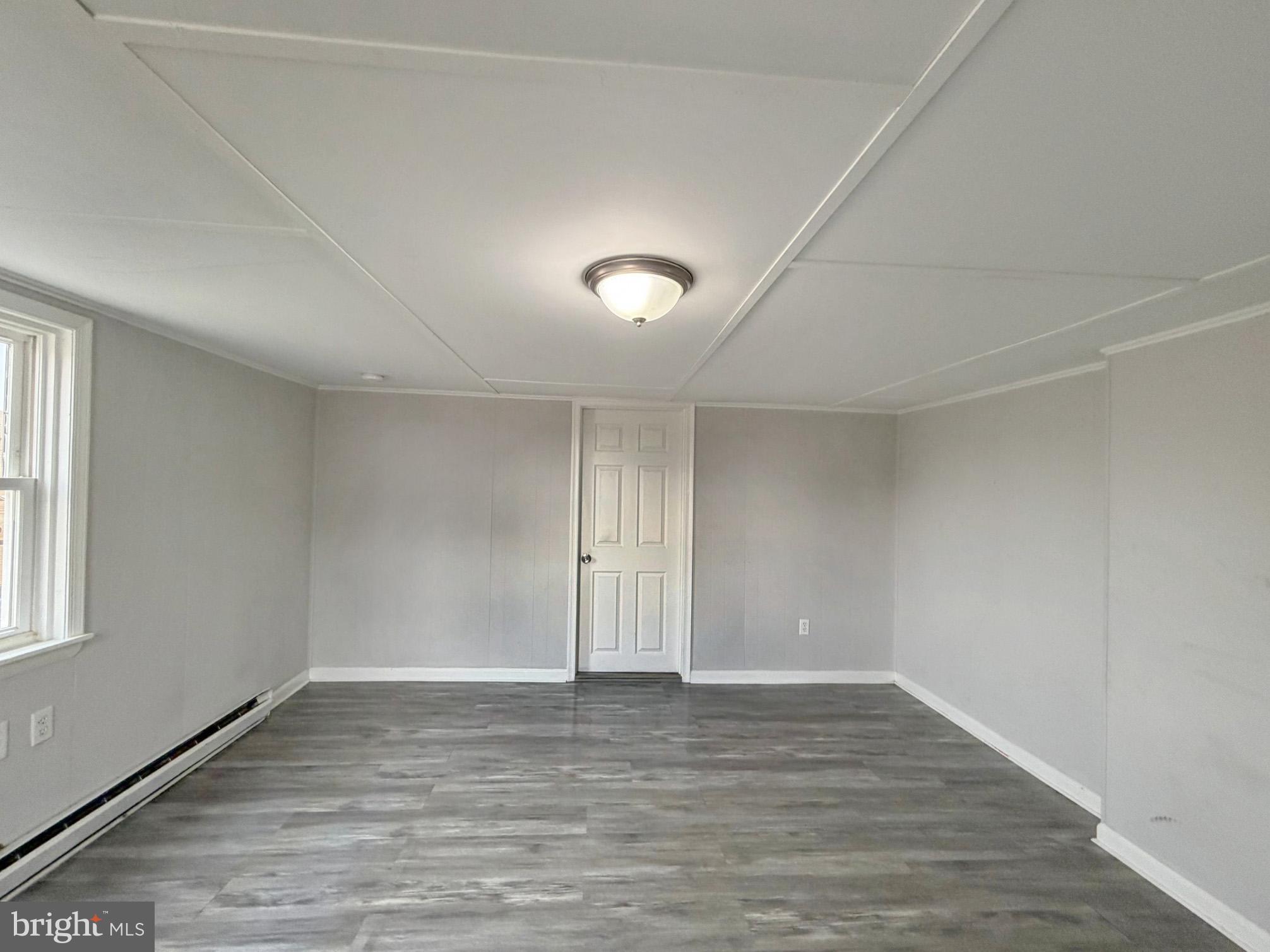 35534 Mt Hermon Road Pittsville, MD 21850 - Photo 26 of 52 an empty room with wooden floor and windows
