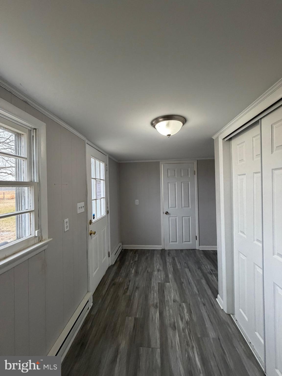 35534 Mt Hermon Road Pittsville, MD 21850 - Photo 27 of 52 a view of an empty room with wooden floor and a window