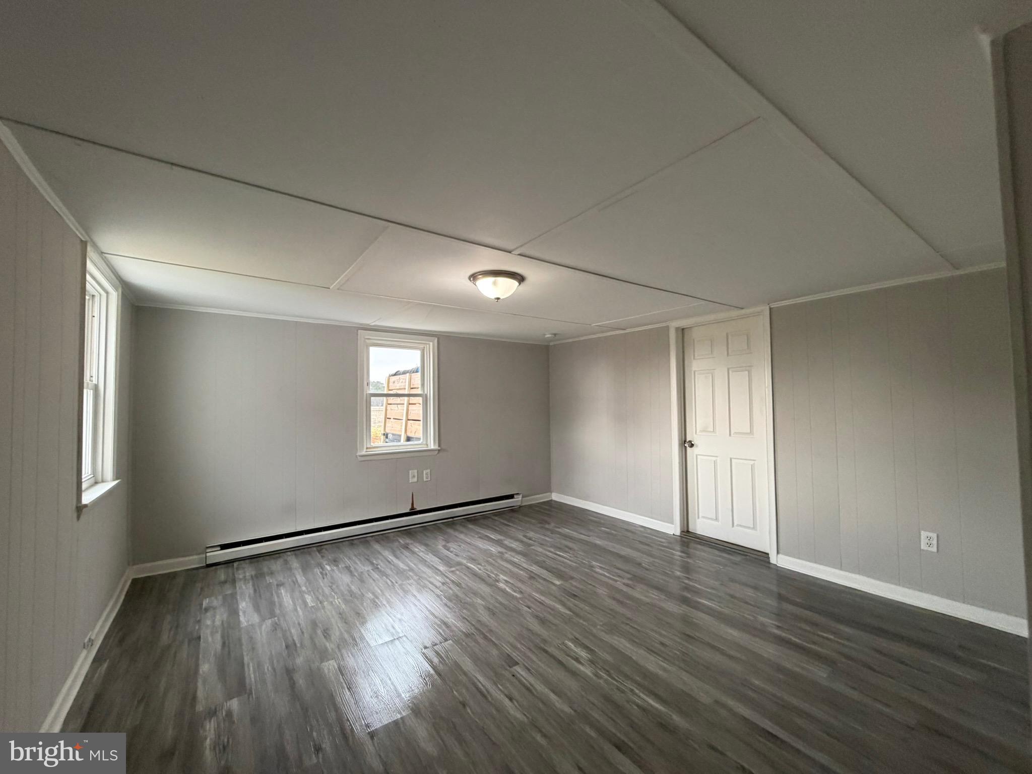 35534 Mt Hermon Road Pittsville, MD 21850 - Photo 33 of 52 a view of an empty room with wooden floor and a window