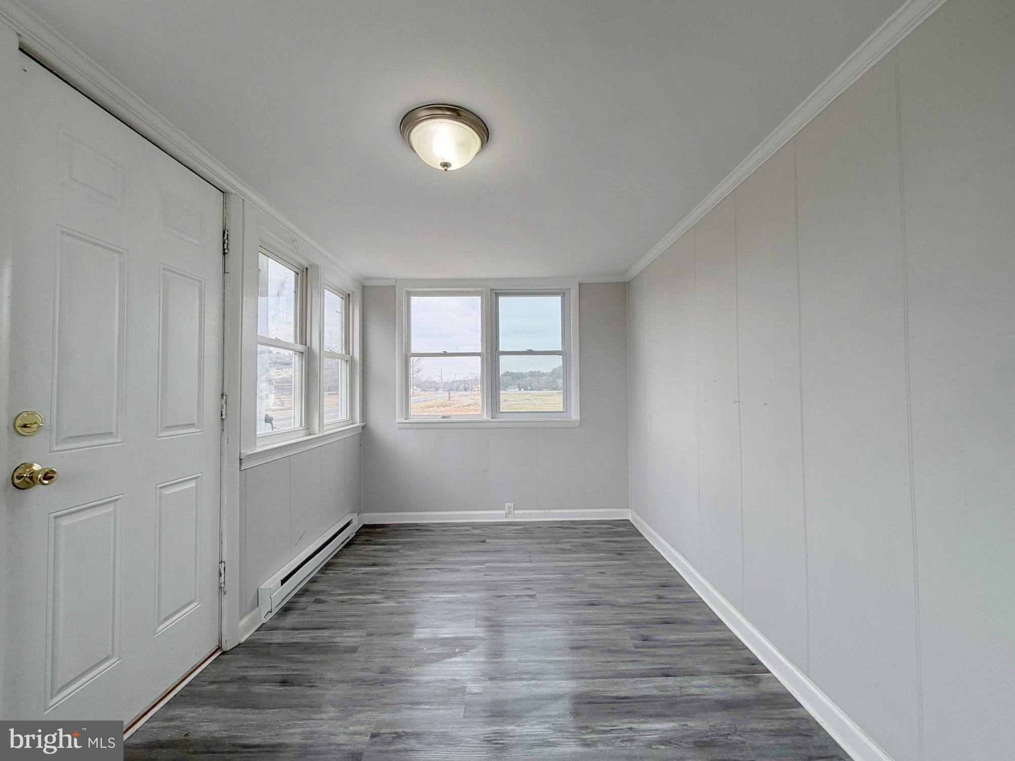 35534 Mt Hermon Road Pittsville, MD 21850 - Photo 6 of 52 wooden floor in an empty room with a window
