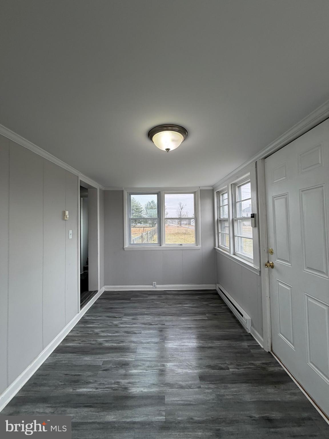 35534 Mt Hermon Road Pittsville, MD 21850 - Photo 7 of 52 an empty room with wooden floor and windows