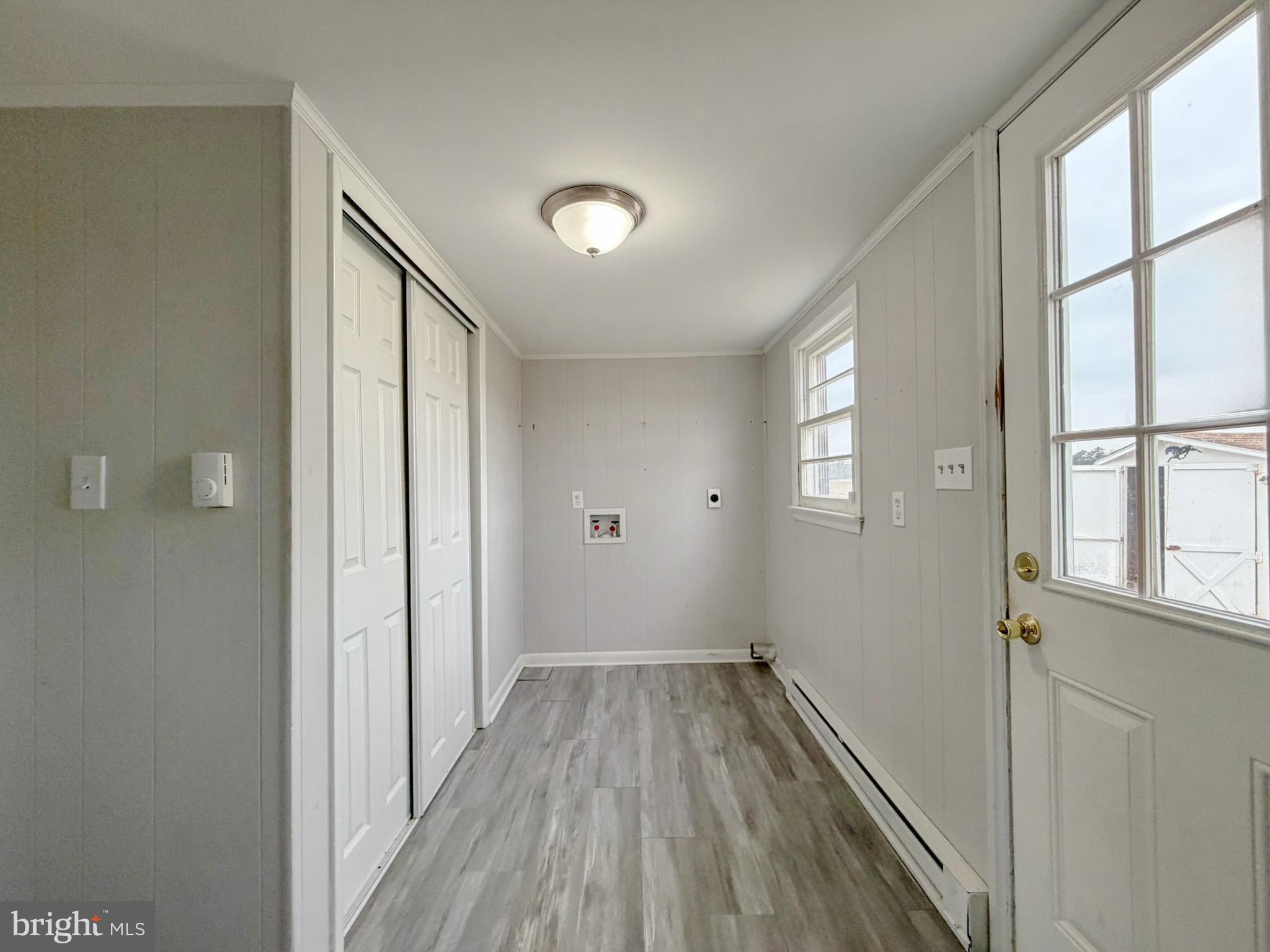 35534 Mt Hermon Road Pittsville, MD 21850 - Photo 8 of 52 a view of a hallway with wooden floor and windows