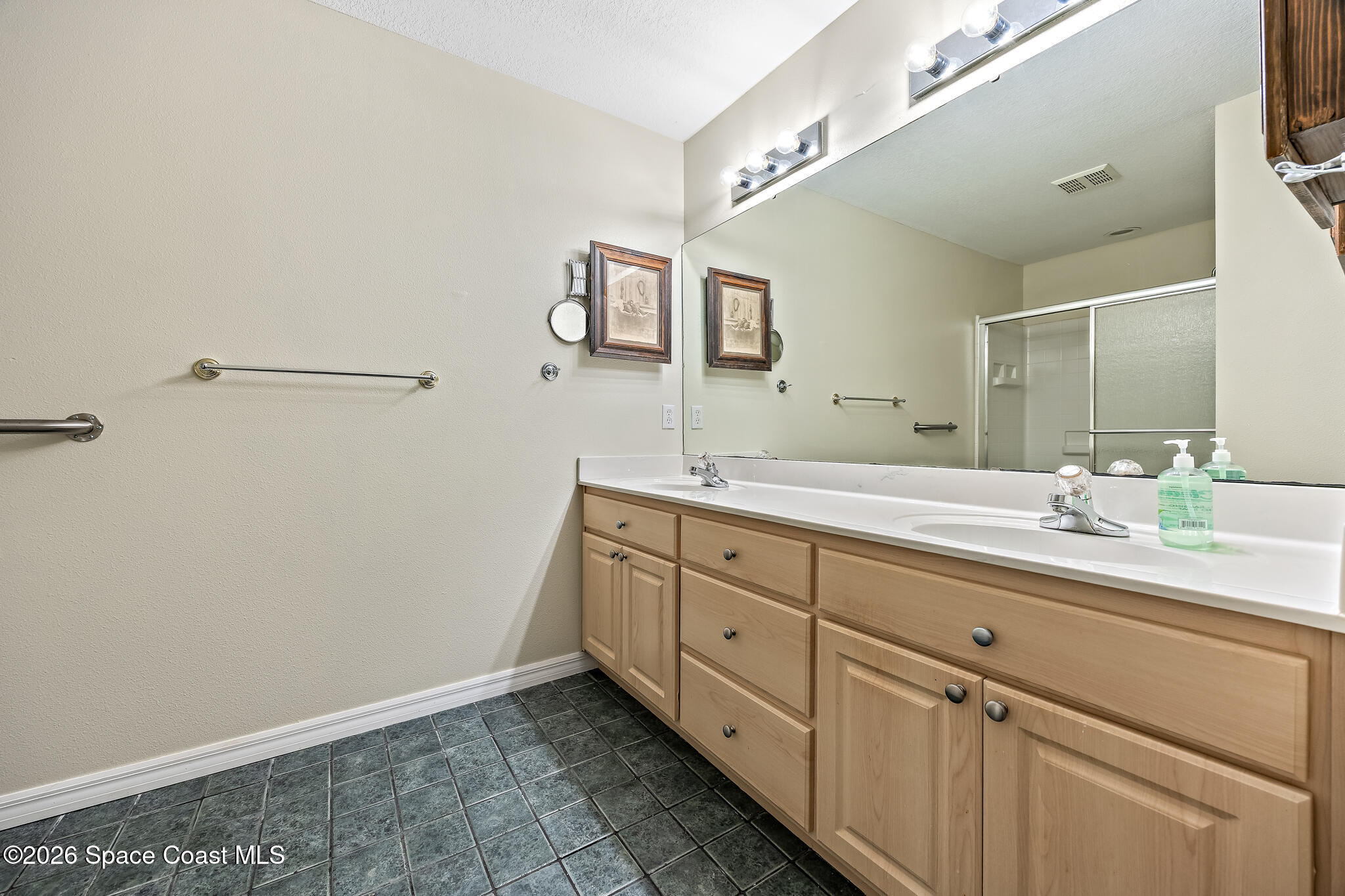 503 Arbor Ridge Lane Titusville, FL 32780 - Photo 18 of 38 a spacious bathroom with 2 sink and mirror