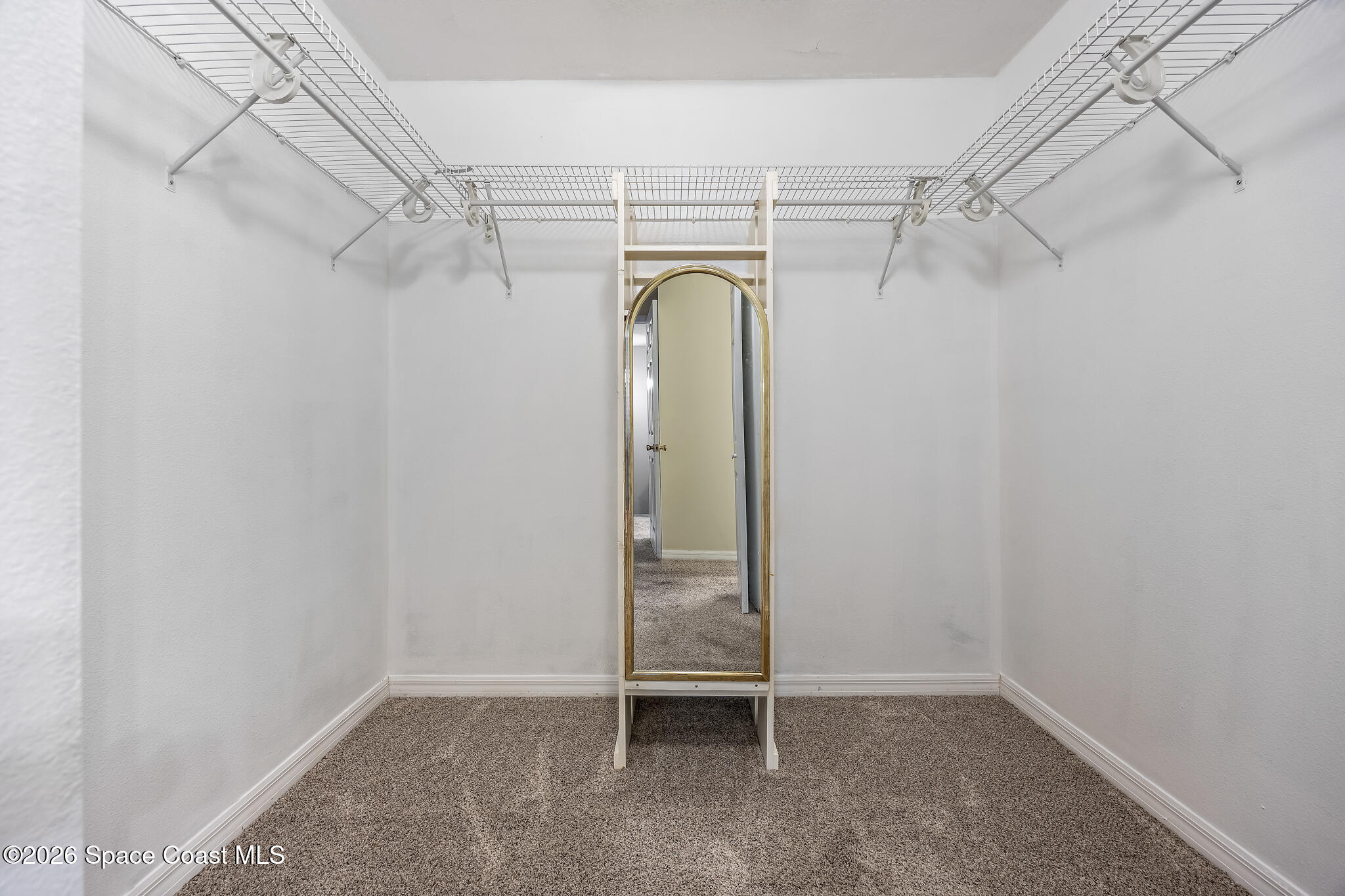 503 Arbor Ridge Lane Titusville, FL 32780 - Photo 20 of 38 a view of walk in closet with empty racks