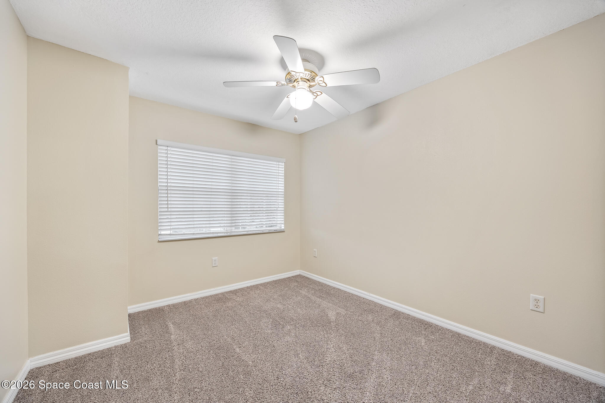 503 Arbor Ridge Lane Titusville, FL 32780 - Photo 24 of 38 an empty room with a window and a fan