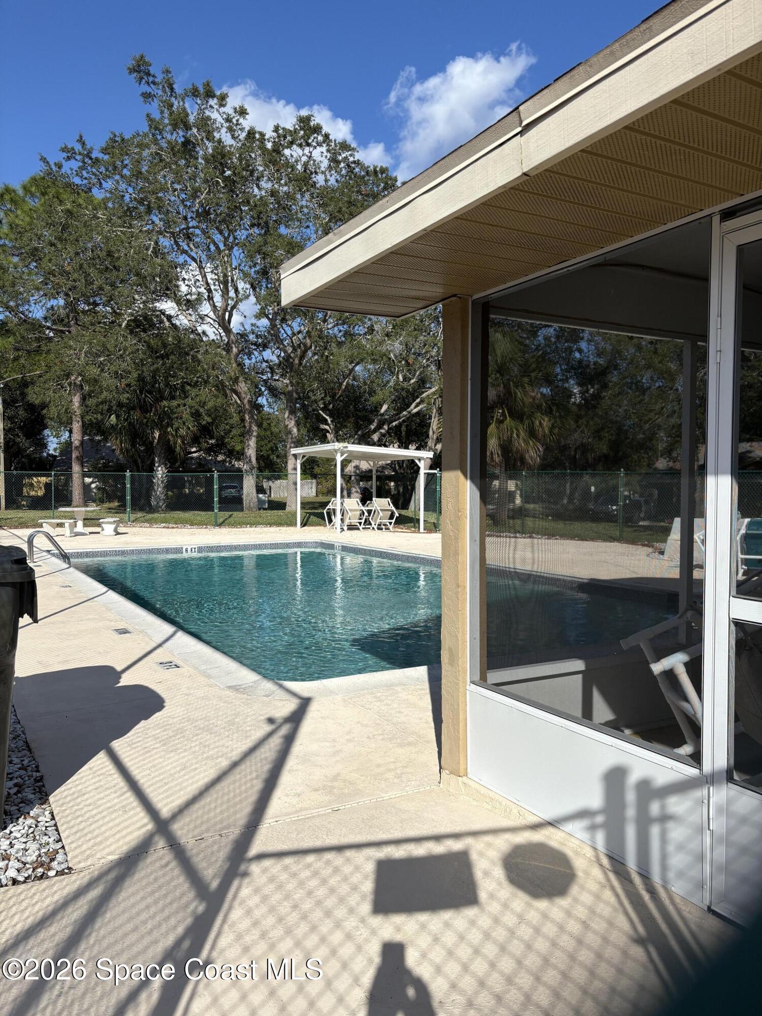 503 Arbor Ridge Lane Titusville, FL 32780 - Photo 34 of 38 a view of a swimming pool with a patio