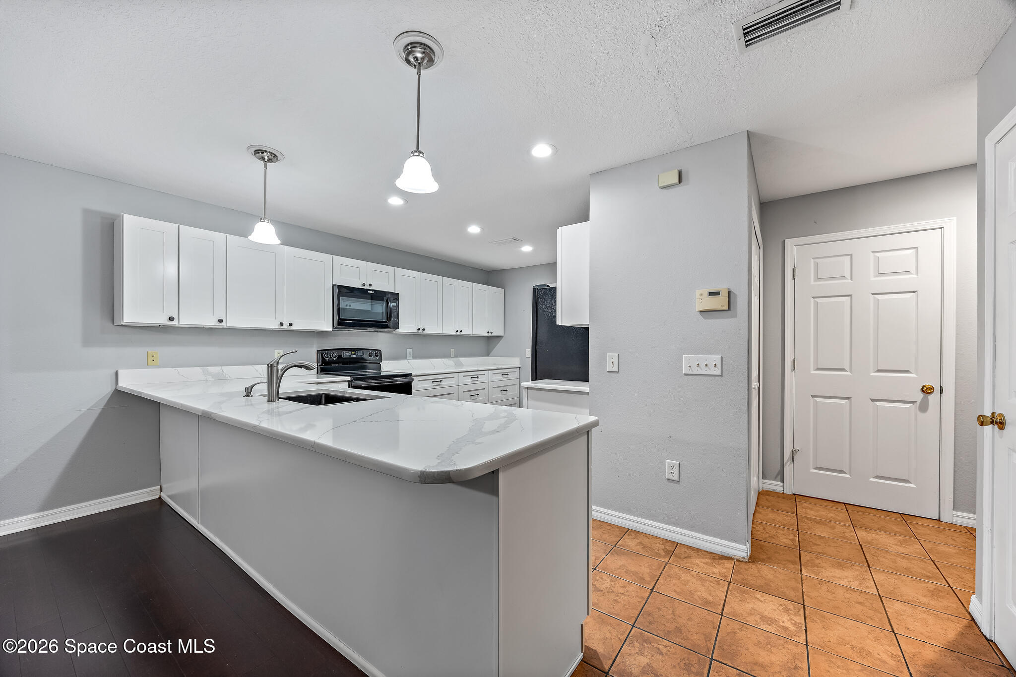 503 Arbor Ridge Lane Titusville, FL 32780 - Photo 6 of 38 a kitchen with stainless steel appliances a sink a stove a refrigerator and white cabinets