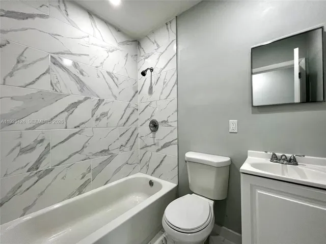a bathroom with a toilet a sink and bathtub
