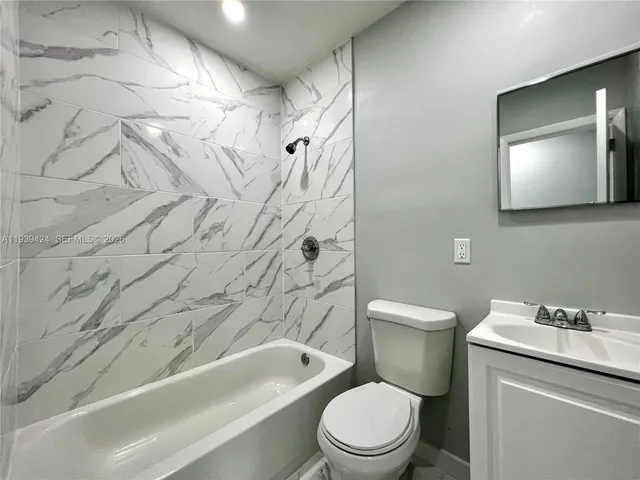 a bathroom with a toilet a sink and bathtub