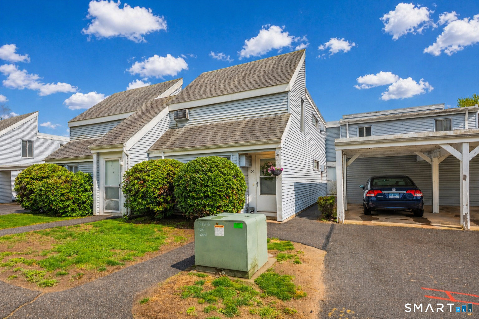 56 Cinnamon Spring, Unit 56 South Windsor, CT 06074 - Photo 1 of 31 a view of a house with a cars park side of a road
