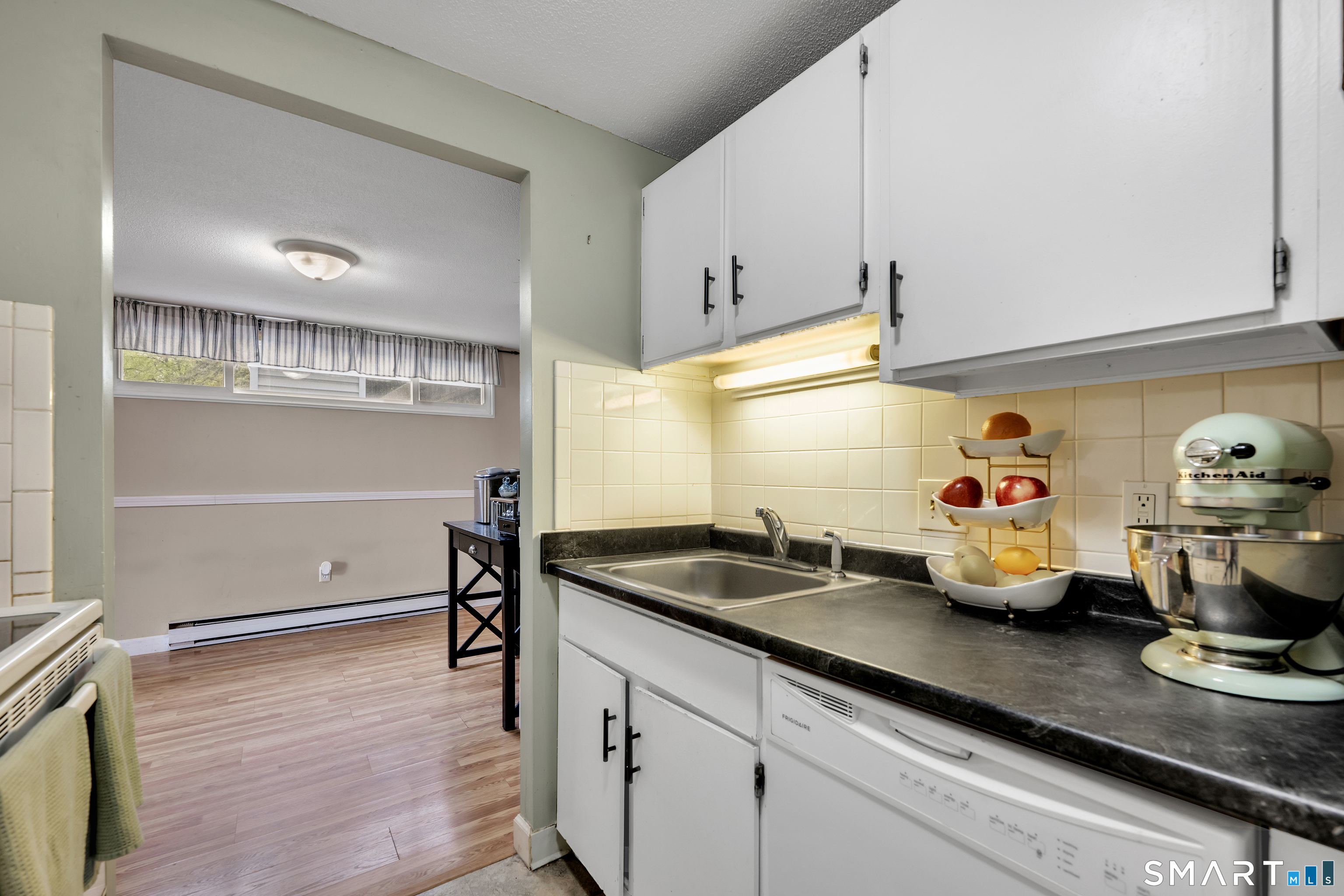 56 Cinnamon Spring, Unit 56 South Windsor, CT 06074 - Photo 12 of 31 a kitchen with stainless steel appliances granite countertop a sink and wooden cabinets