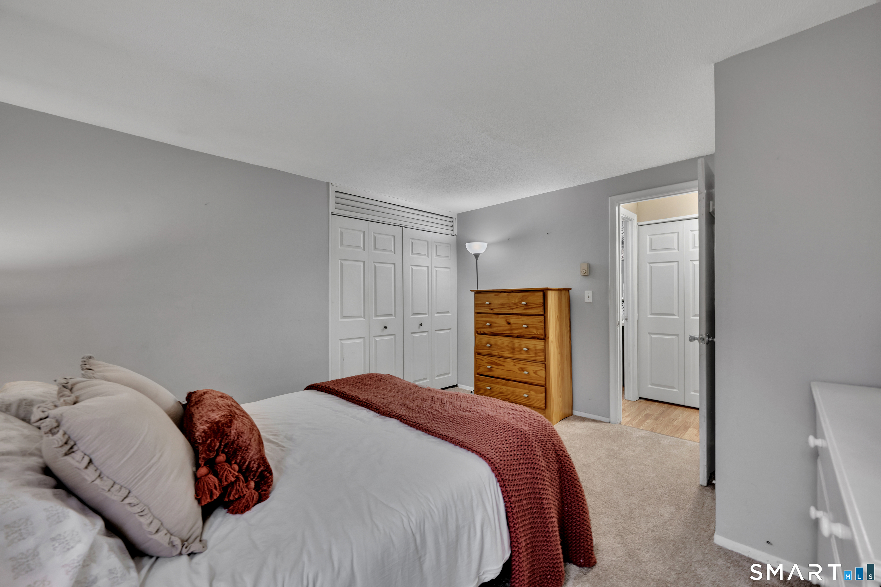 56 Cinnamon Spring, Unit 56 South Windsor, CT 06074 - Photo 16 of 31 a bedroom with a bed and a closet