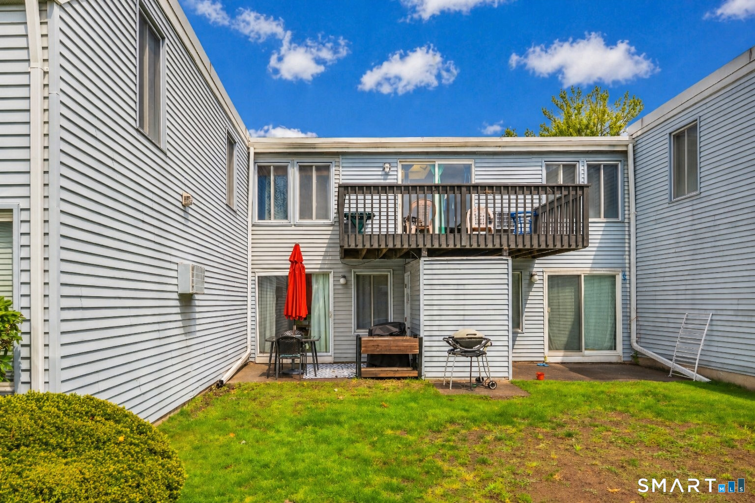 56 Cinnamon Spring, Unit 56 South Windsor, CT 06074 - Photo 22 of 31 a view of a house with a small yard and a large tree