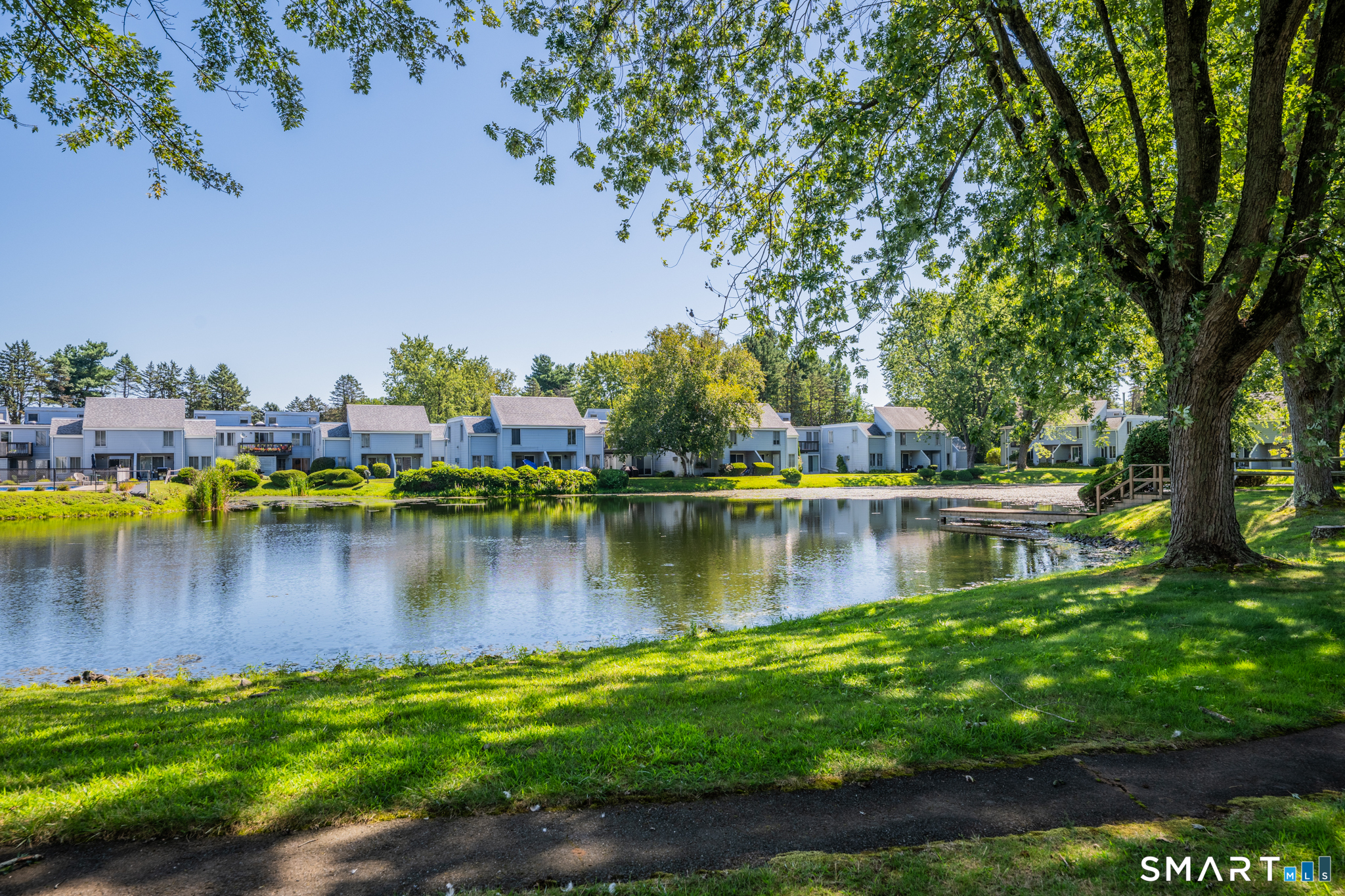 56 Cinnamon Spring, Unit 56 South Windsor, CT 06074 - Photo 28 of 31 a view of a lake with a trees in the background