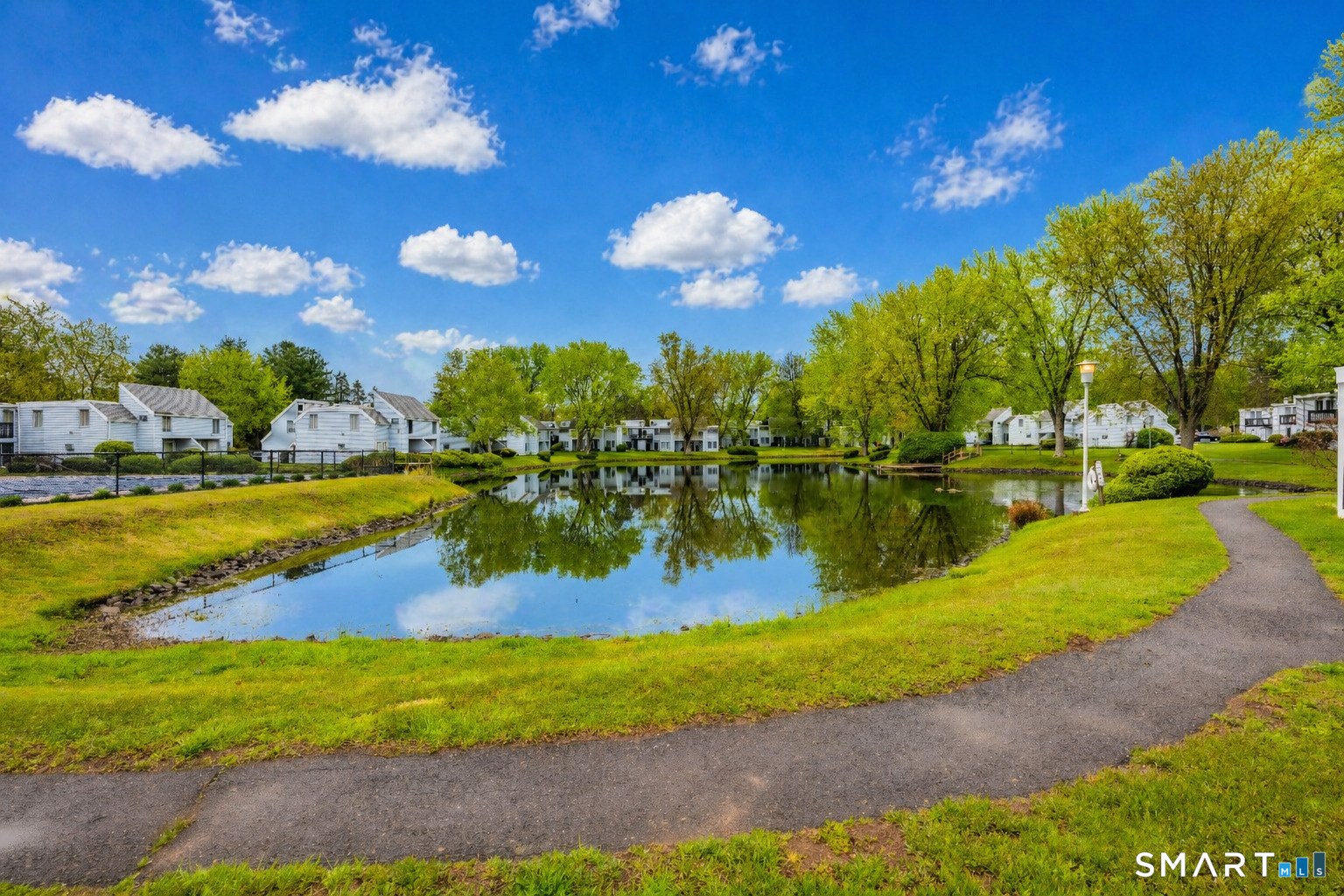56 Cinnamon Spring, Unit 56 South Windsor, CT 06074 - Photo 30 of 31 a view of a lake with houses in the back