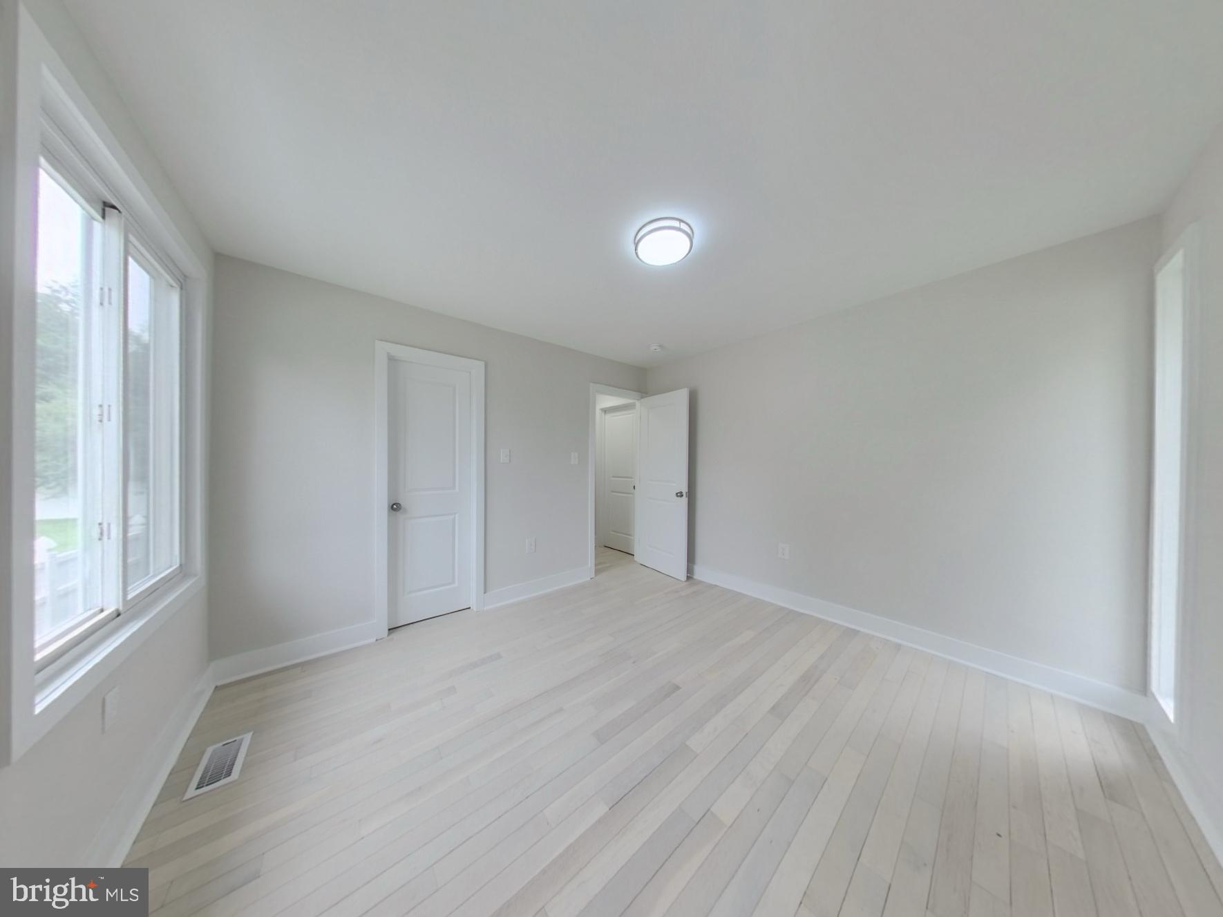 7803 Fordson Road Alexandria, VA 22306 - Photo 15 of 30 wooden floor in an empty room with a window