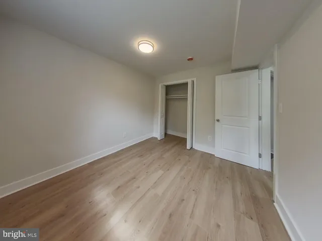 a view of wooden floor and windows in a room
