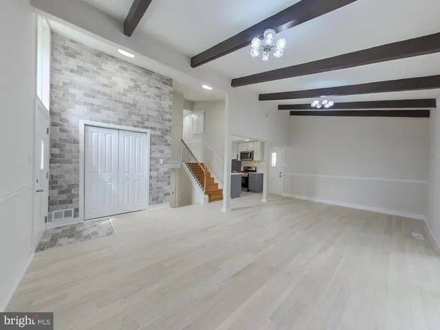 a view of an empty room with a fireplace