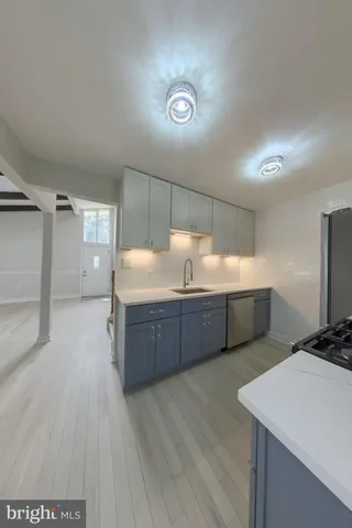 a kitchen with stainless steel appliances sink refrigerator and microwave