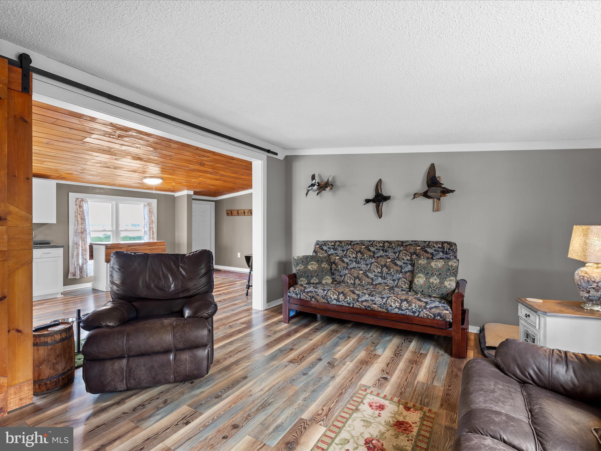 2765 Hoopers Island Road Fishing Creek, MD 21634 - Photo 27 of 111 a living room with furniture and a large window
