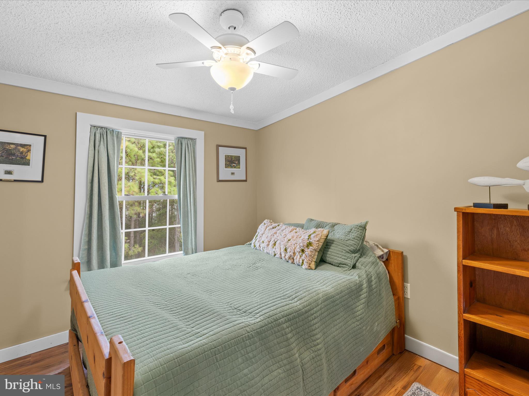2765 Hoopers Island Road Fishing Creek, MD 21634 - Photo 29 of 111 a bedroom with a bed and a chandelier