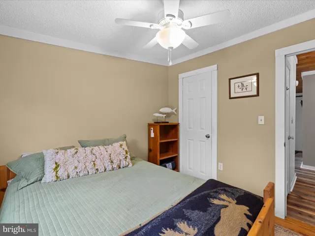 a view of a swimming pool with lawn chairs and a yard