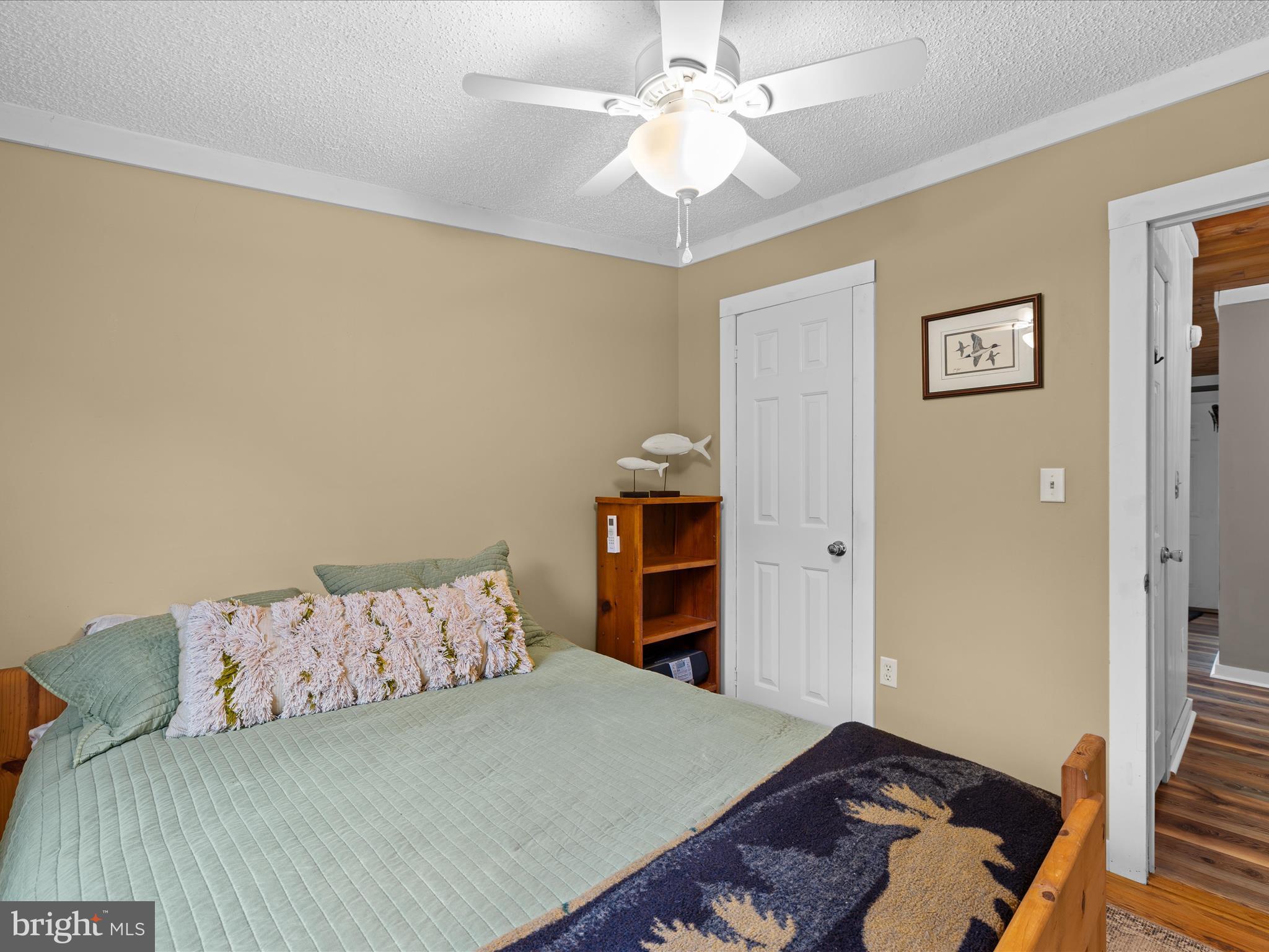 2765 Hoopers Island Road Fishing Creek, MD 21634 - Photo 30 of 111 a bedroom with a bed and a chandelier