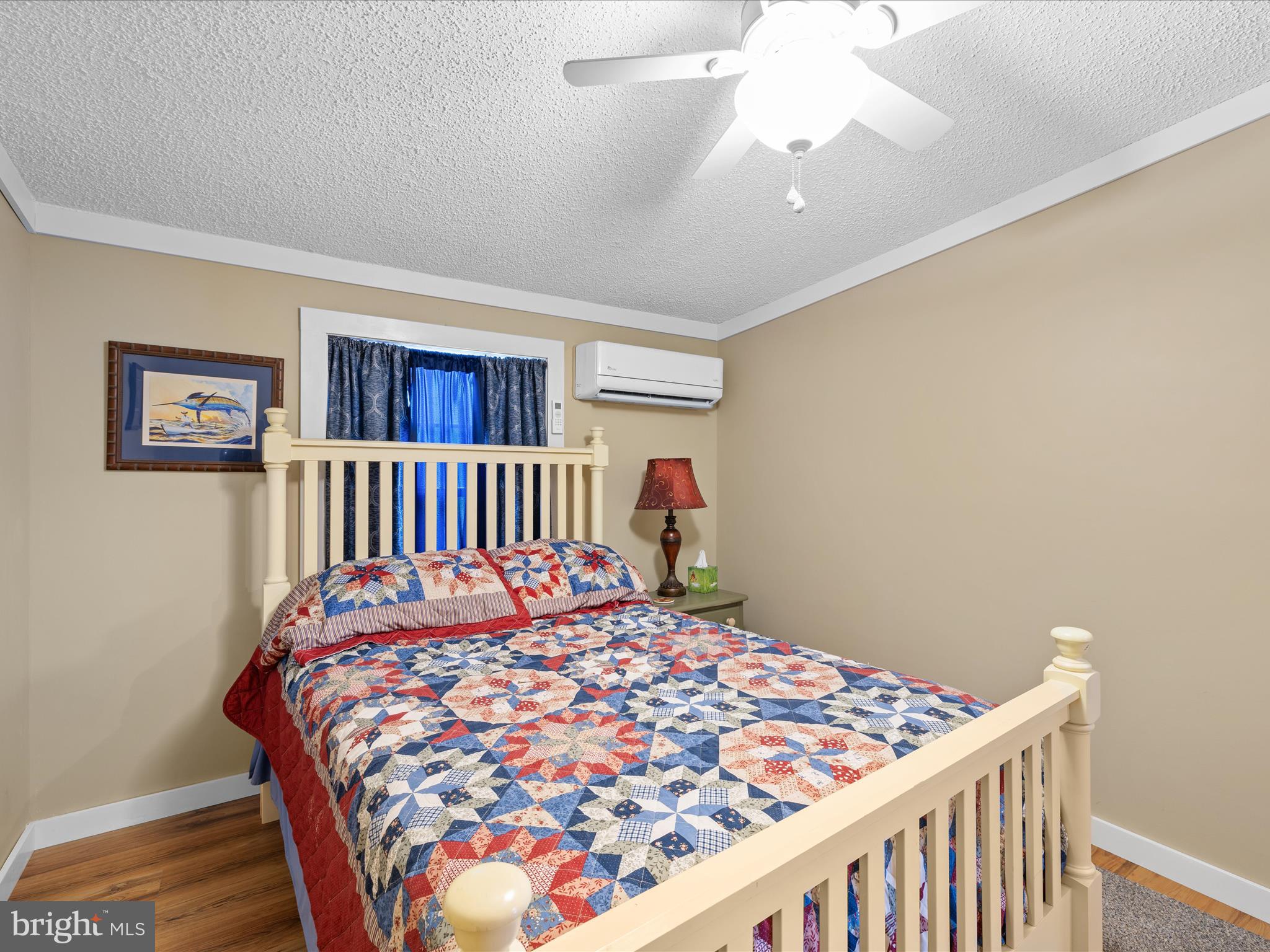 2765 Hoopers Island Road Fishing Creek, MD 21634 - Photo 34 of 111 a bedroom with a bed and a chandelier