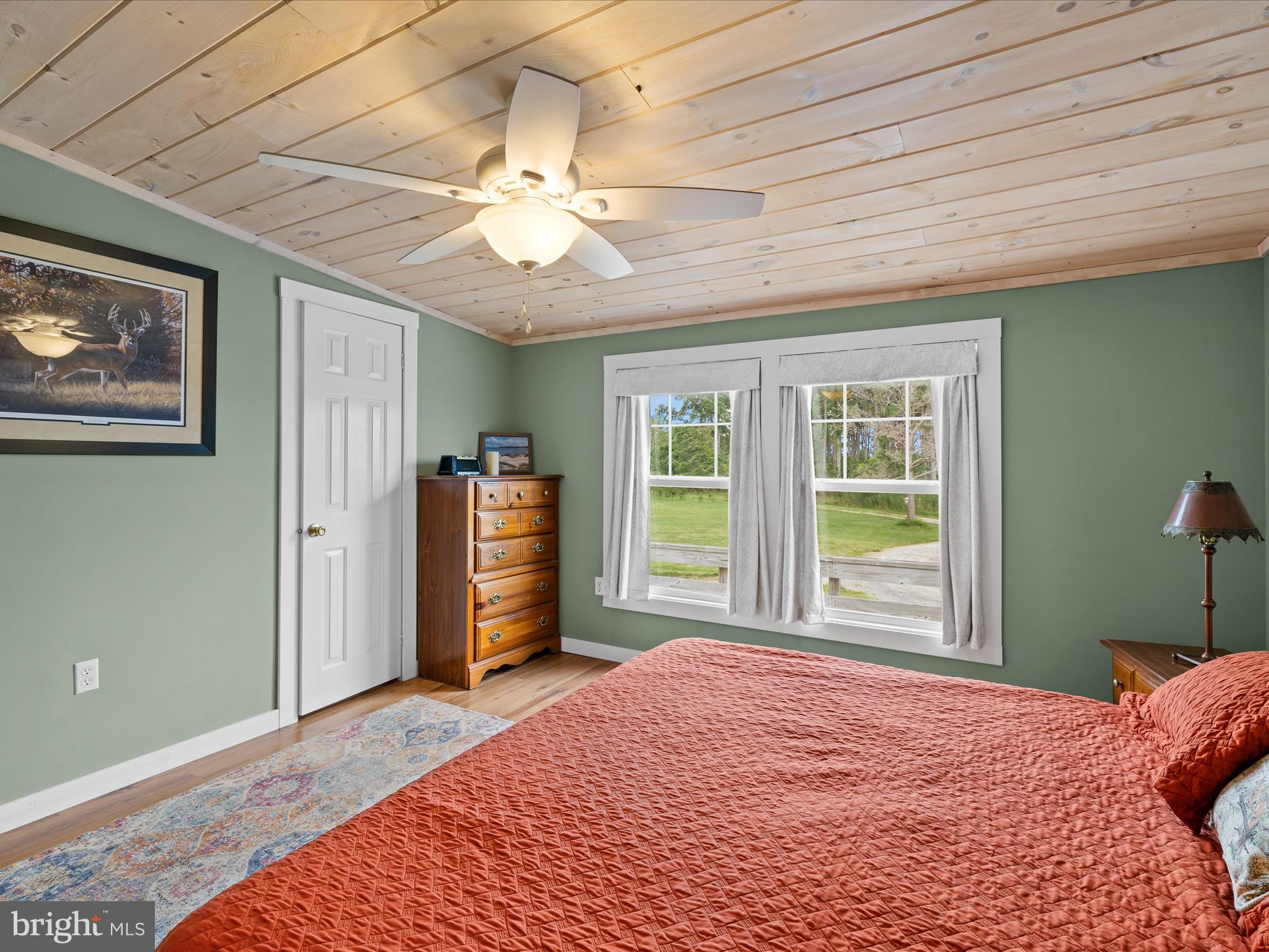 2765 Hoopers Island Road Fishing Creek, MD 21634 - Photo 38 of 111 a bedroom with a bed and a chandelier