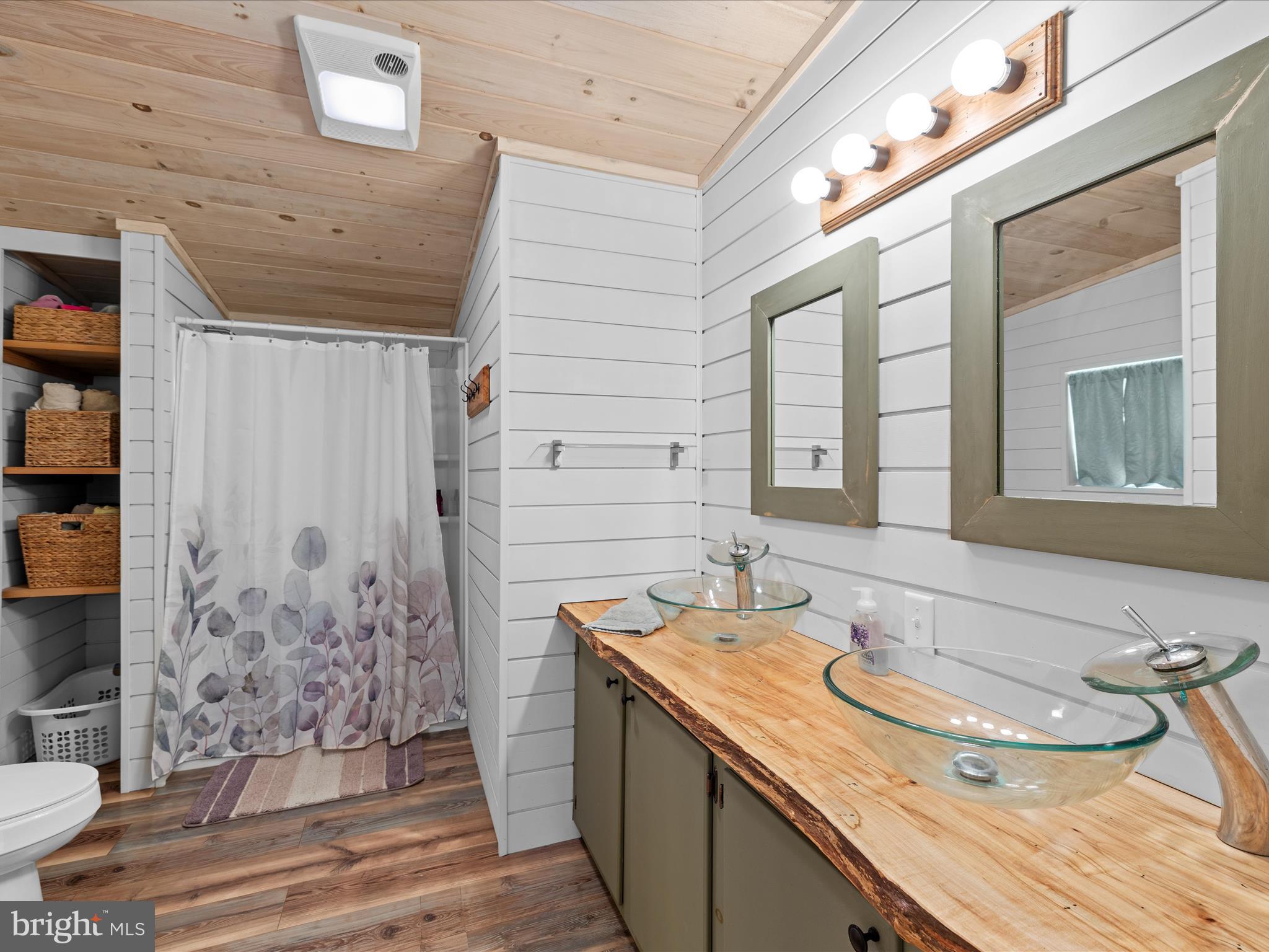 2765 Hoopers Island Road Fishing Creek, MD 21634 - Photo 39 of 111 a bathroom with a granite countertop sink and a mirror