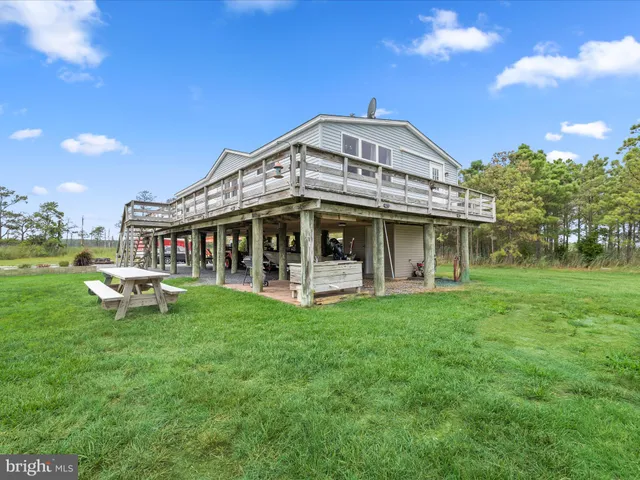 a aerial view of a house with a yard and lake view