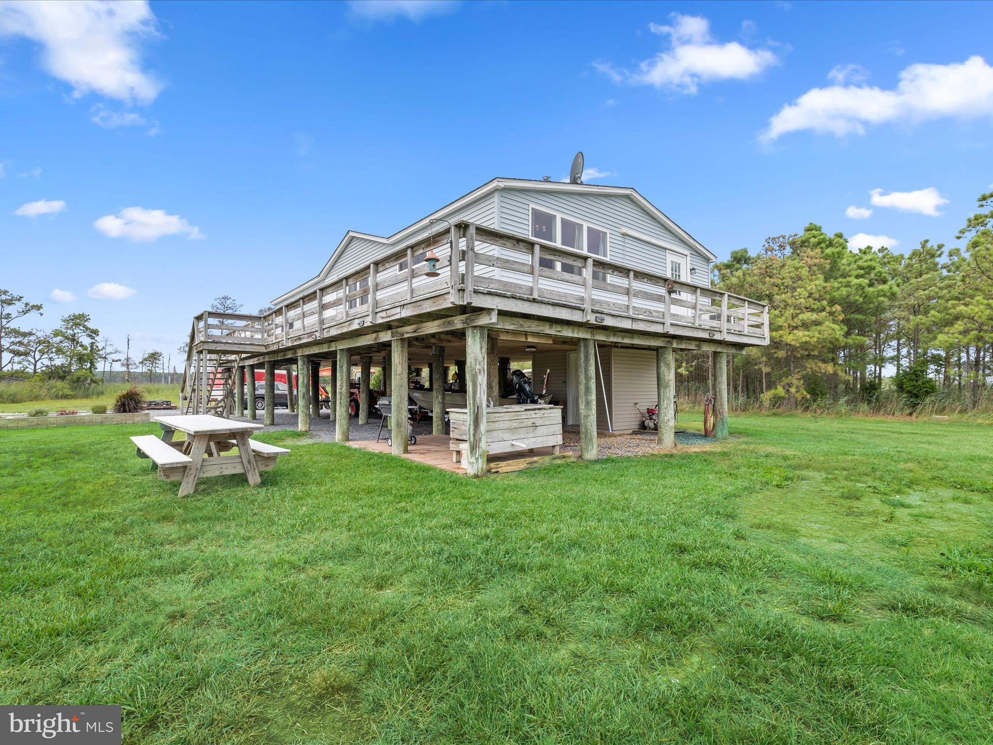 2765 Hoopers Island Road Fishing Creek, MD 21634 - Photo 6 of 111 a view of a house with a yard balcony and sitting area