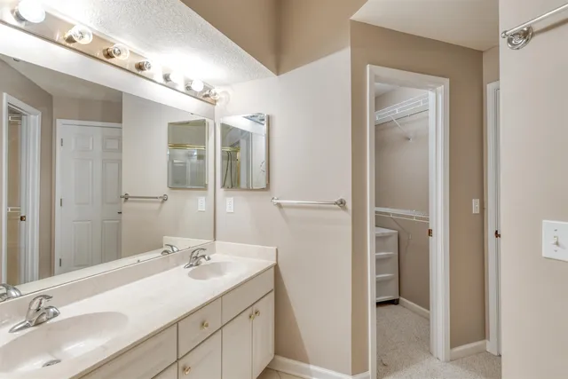 a bathroom with a sink double vanity and a mirror