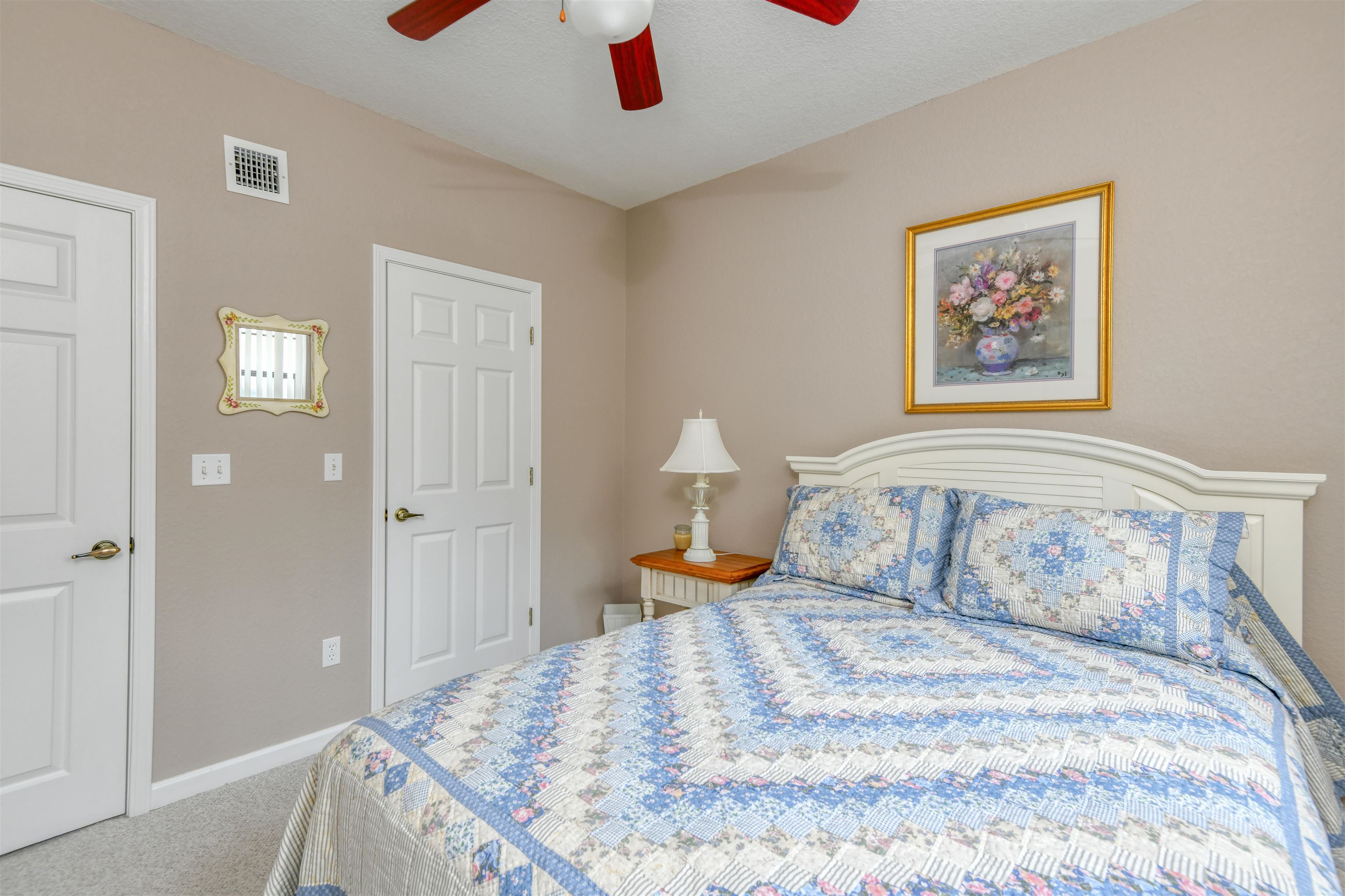 2202 Vista Cove Road St. Augustine, FL 32084 - Photo 16 of 38 a bedroom with a bed and a painting on the wall