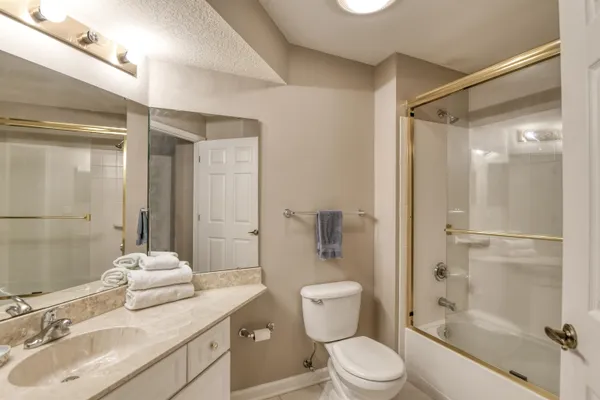 a bathroom with a sink toilet tub and shower