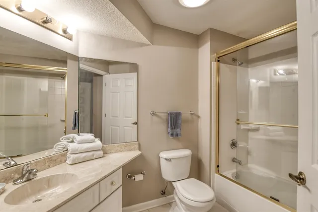 a bathroom with a sink toilet tub and shower