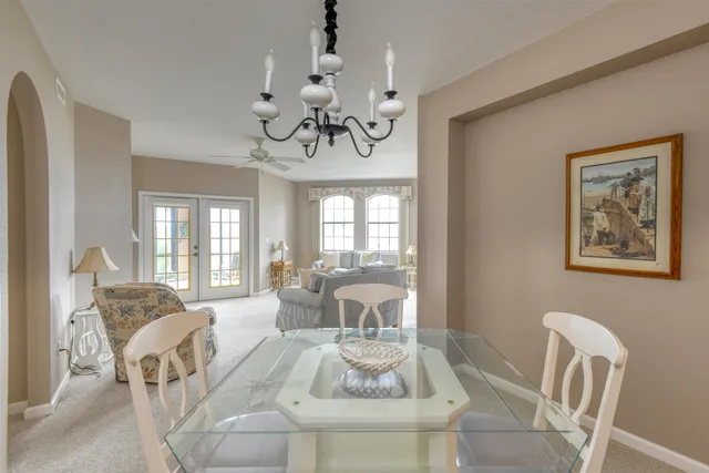 a view of a dining room with furniture wooden floor and chandelier