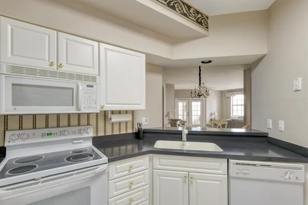 a kitchen with stainless steel appliances granite countertop a sink and cabinets