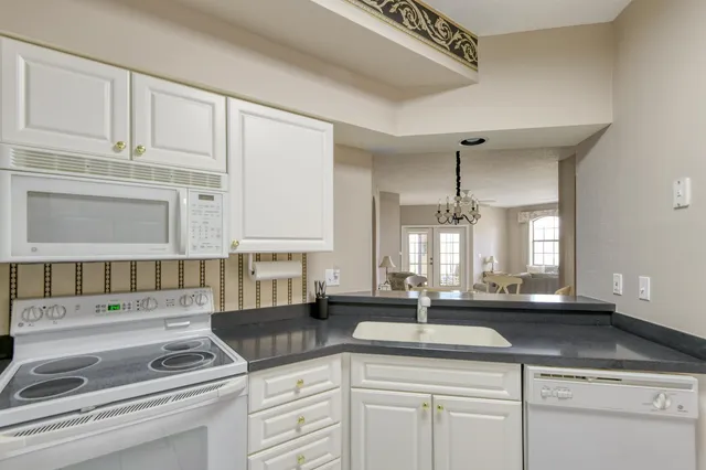 a kitchen with stainless steel appliances granite countertop a sink and cabinets