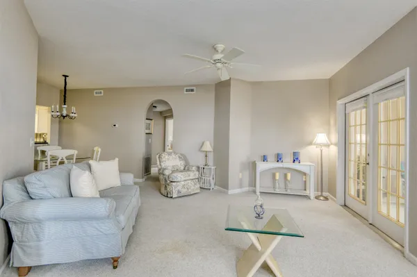 a living room with furniture a window and a chandelier