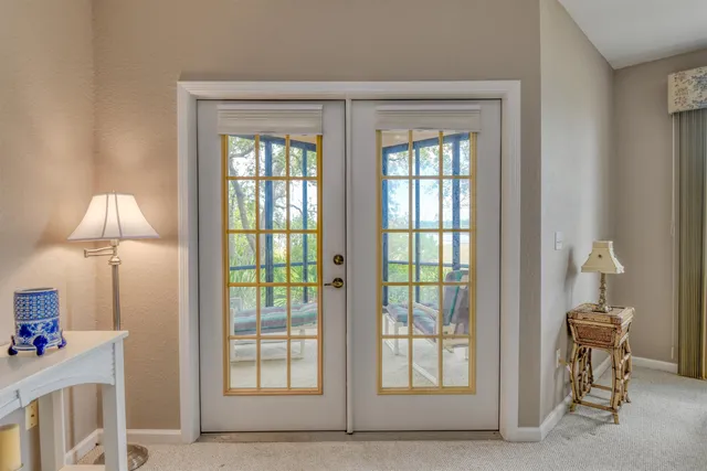 a view of empty room with furniture and a window