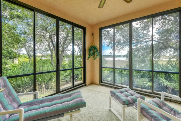 a living room with furniture and a floor to ceiling window