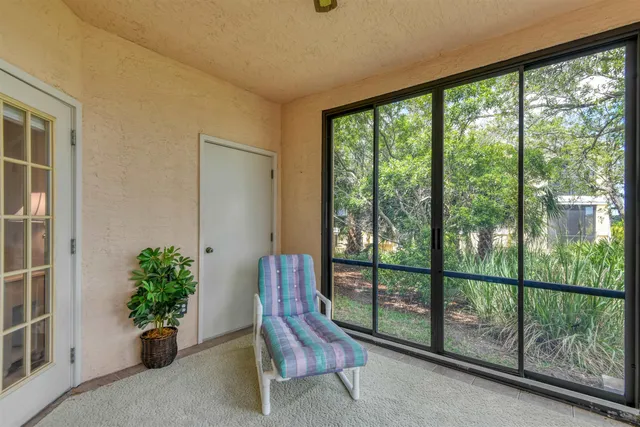 a view of a room with furniture and floor to ceiling window