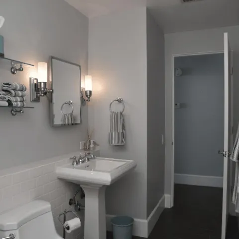 a bathroom with a sink toilet and a mirror