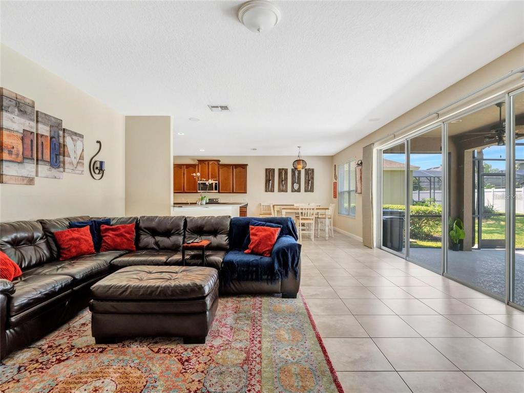 10023 Ians Ridge Road Orlando, FL 32832 - Photo 14 of 60 a living room with furniture and a flat screen tv