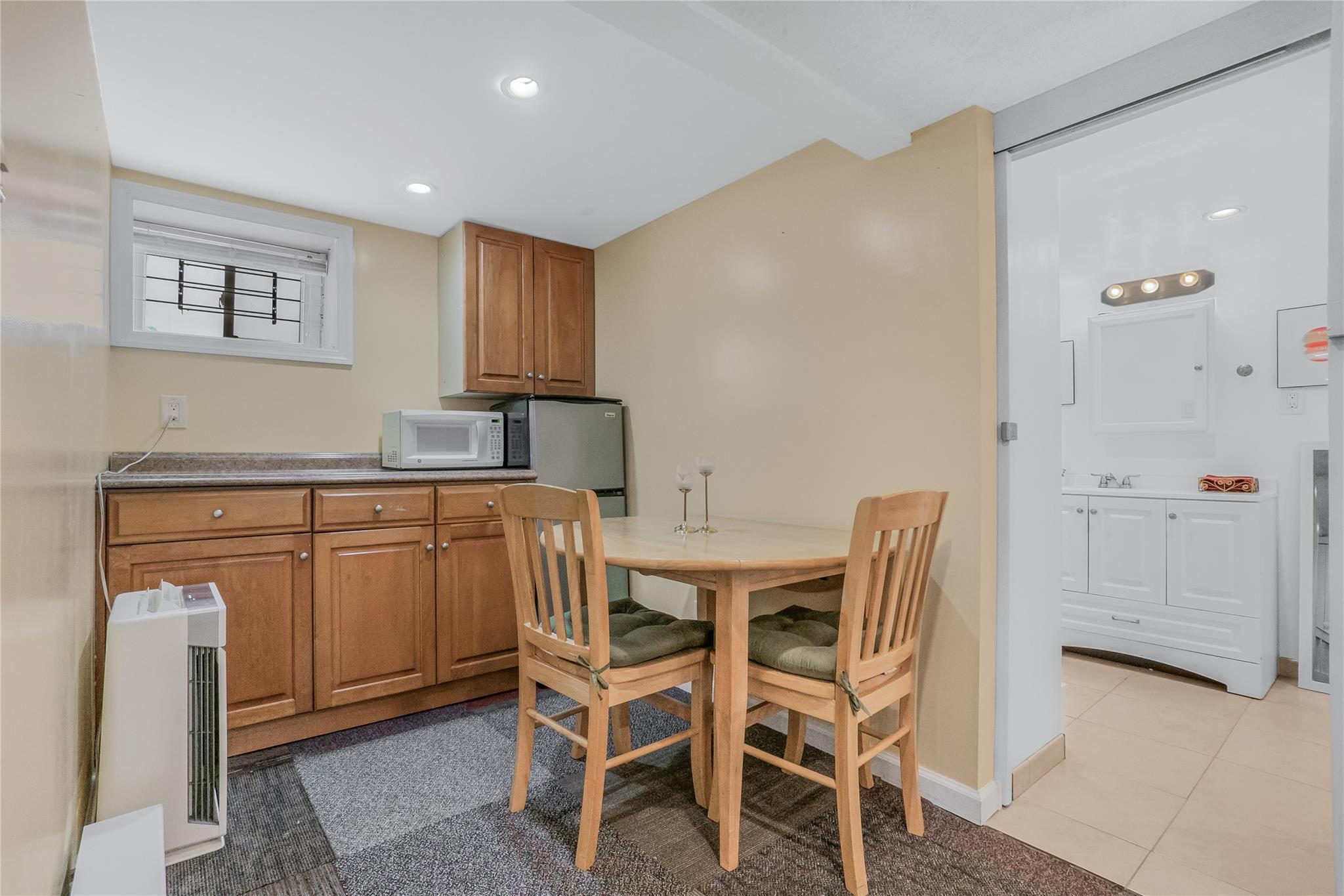 90-21 218th Place Queens, NY 11428 - Photo 12 of 21 a kitchen with cabinets and chairs