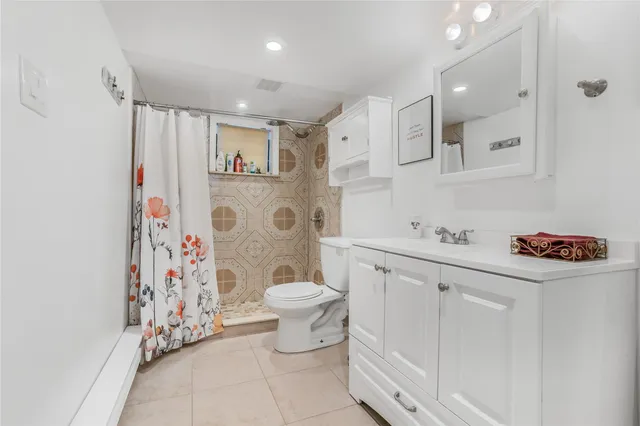 a view of a patio with table and chairs under an umbrella