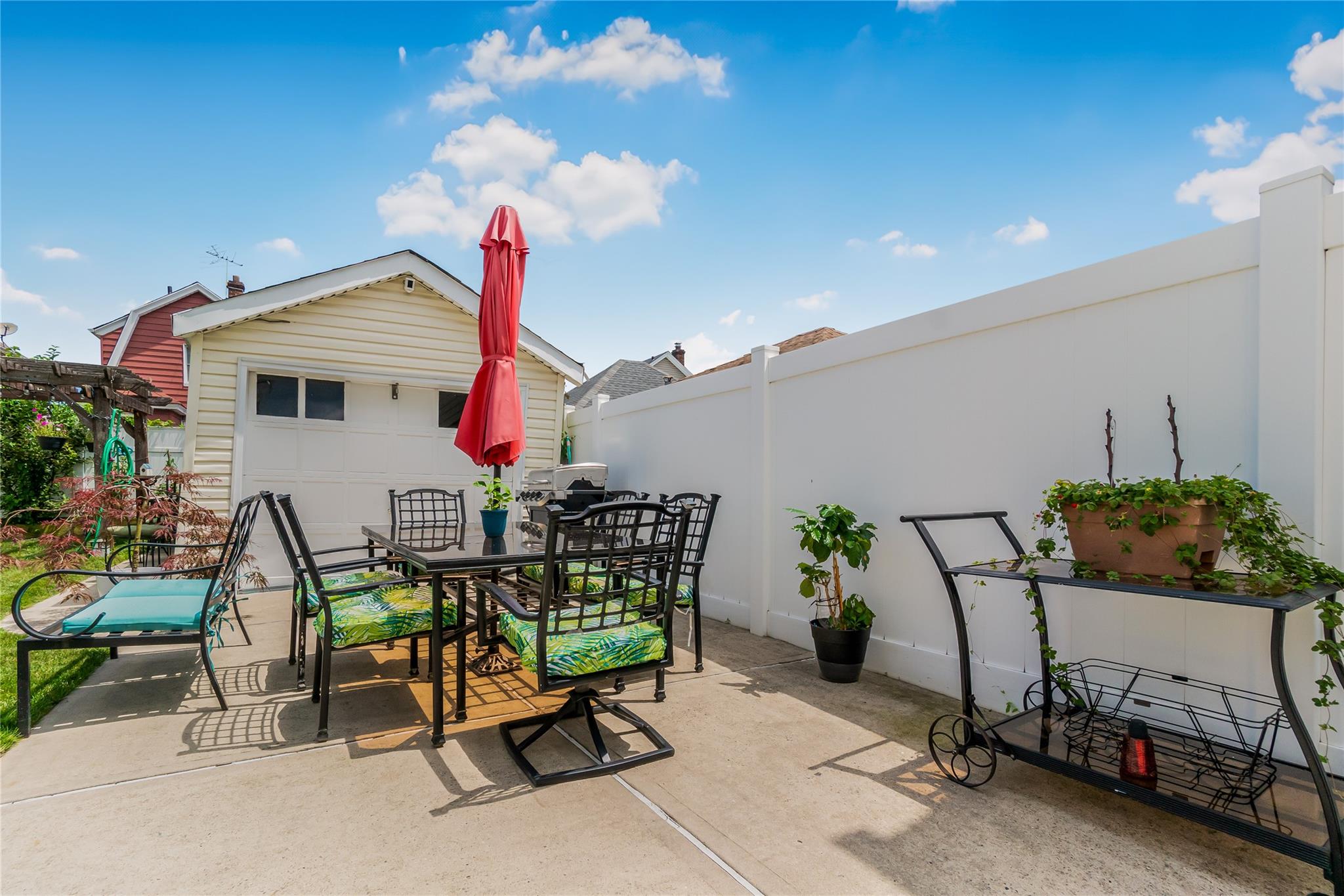 90-21 218th Place Queens, NY 11428 - Photo 15 of 21 a view of a chairs and table in patio