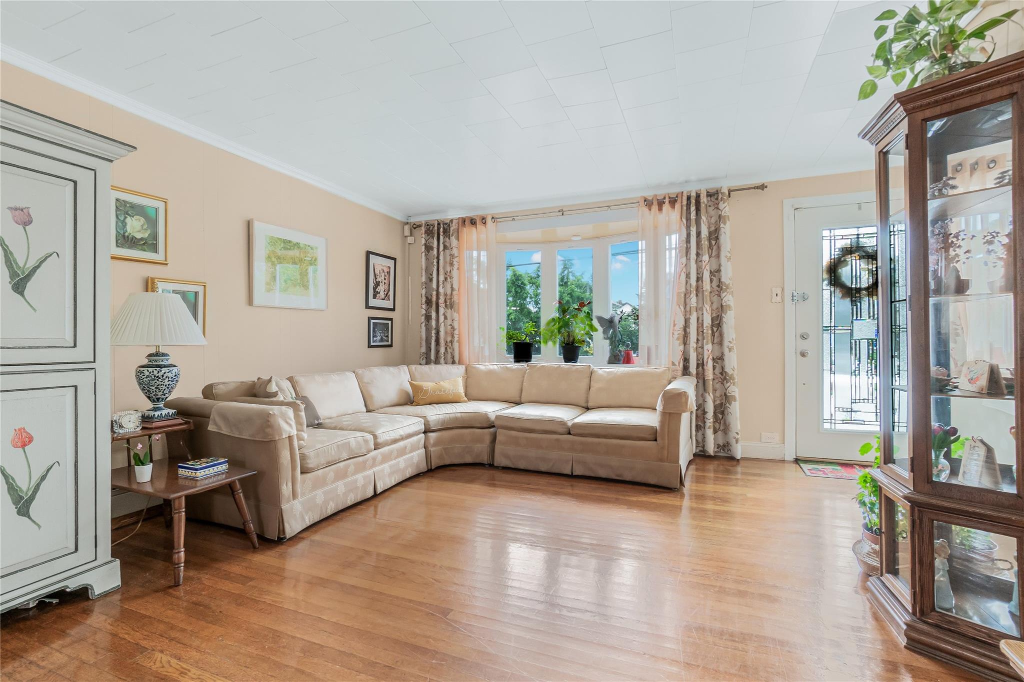 90-21 218th Place Queens, NY 11428 - Photo 3 of 21 a living room with furniture and a large window